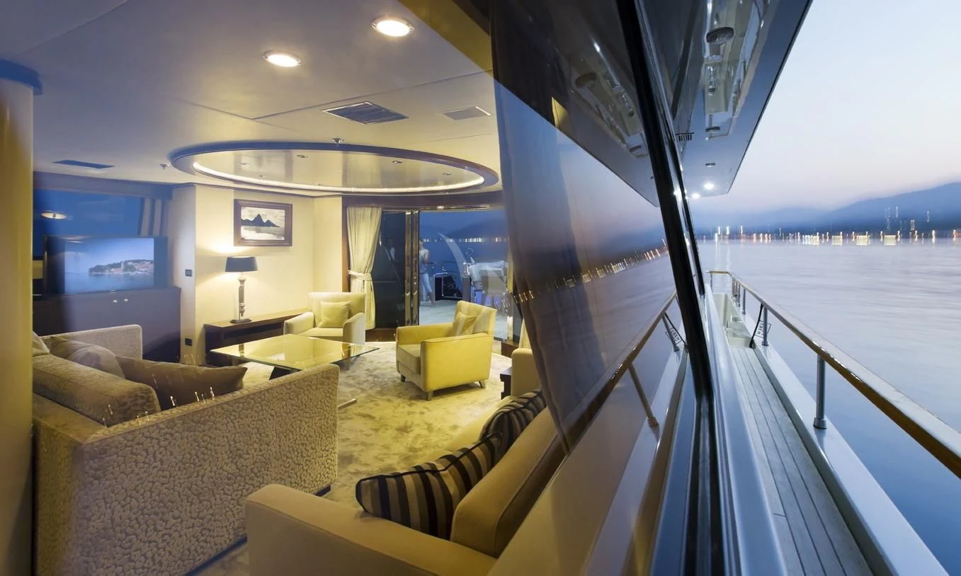a living room with a balcony aboard XO OF THE SEAS Yacht for Sale