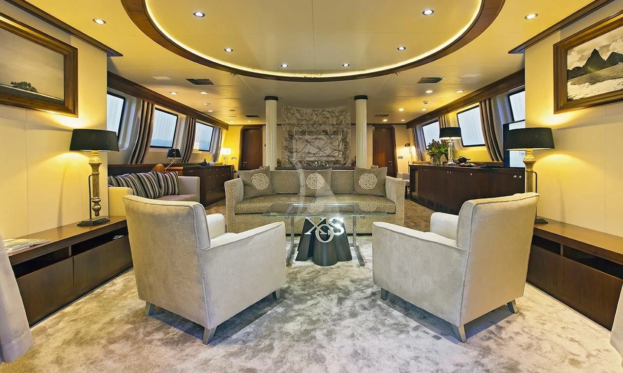 a living room with a couch and a coffee table aboard XO OF THE SEAS Yacht for Sale