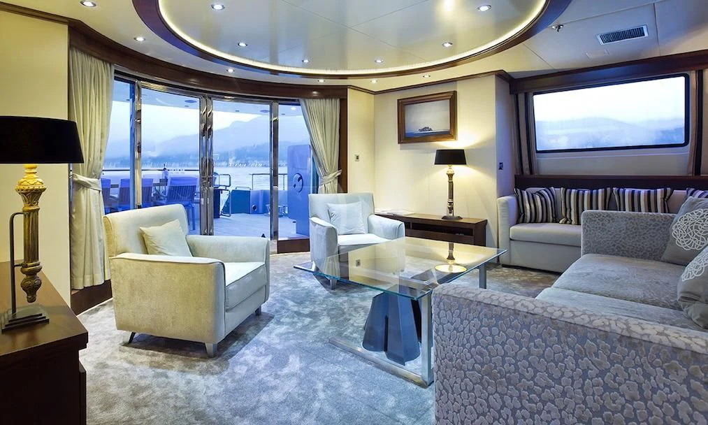 a living room with a large window aboard XO OF THE SEAS Yacht for Sale