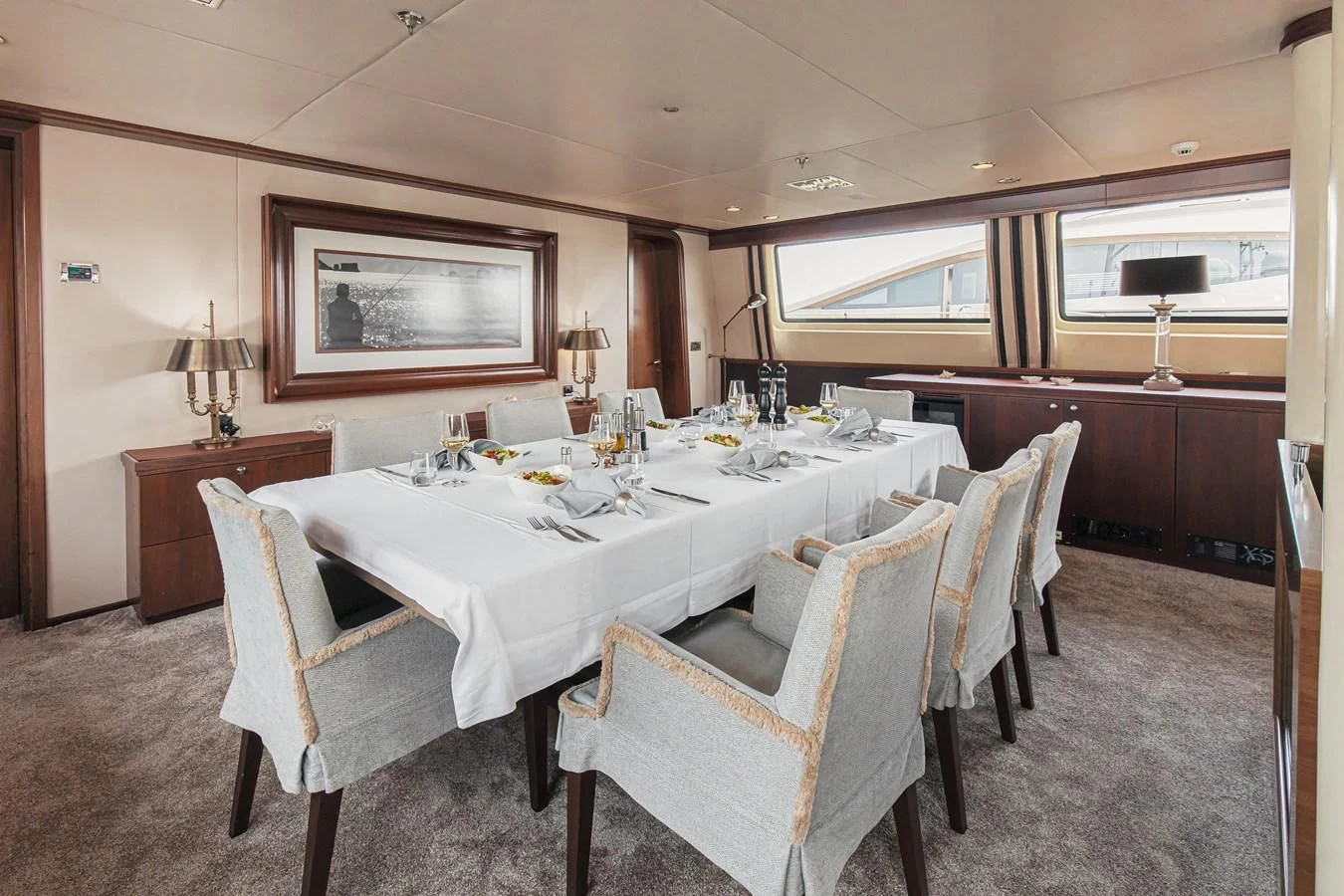 a dining table in a room aboard XO OF THE SEAS Yacht for Sale