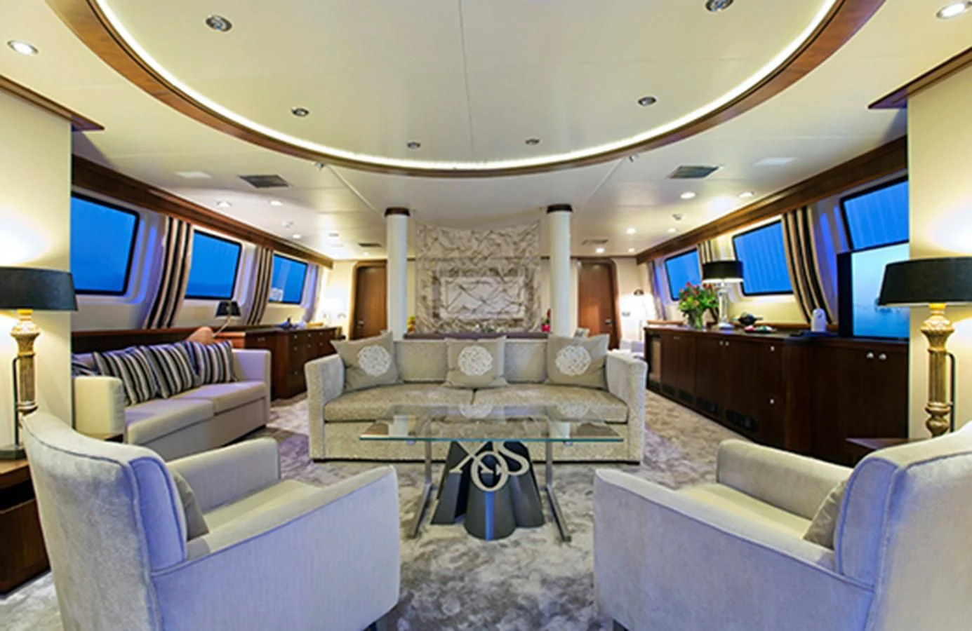 a living room with a large sofa aboard XO OF THE SEAS Yacht for Sale