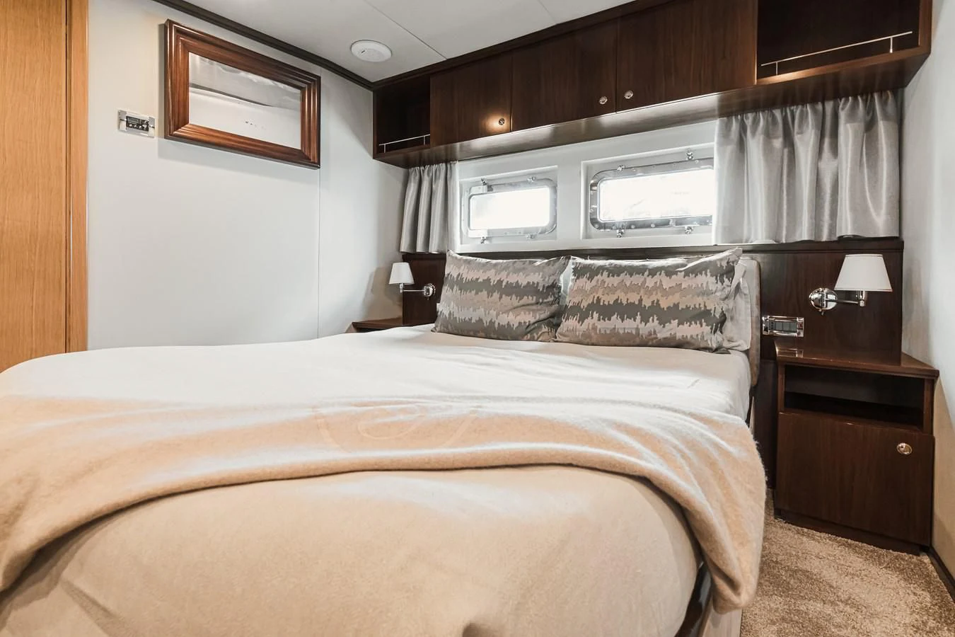a bed with a white comforter aboard XO OF THE SEAS Yacht for Sale