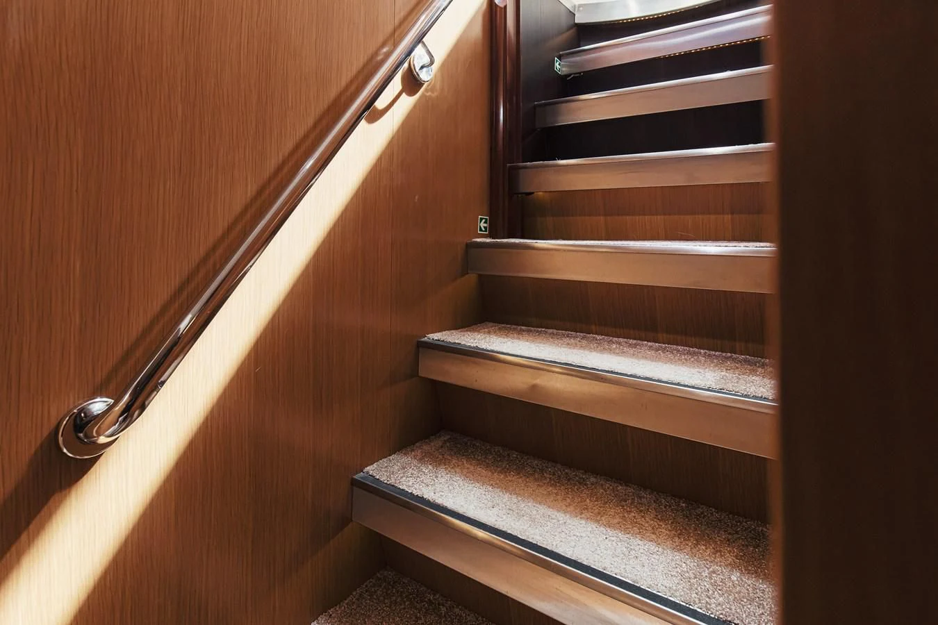 a wooden staircase with wooden railings aboard XO OF THE SEAS Yacht for Sale
