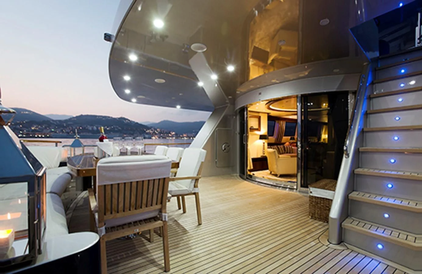 a room with a view of the water and mountains aboard XO OF THE SEAS Yacht for Sale