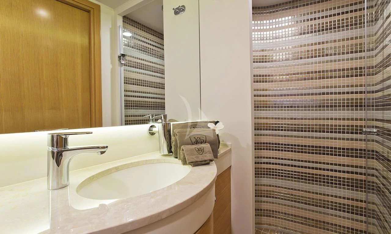 a bathroom with a sink and a mirror aboard XO OF THE SEAS Yacht for Sale