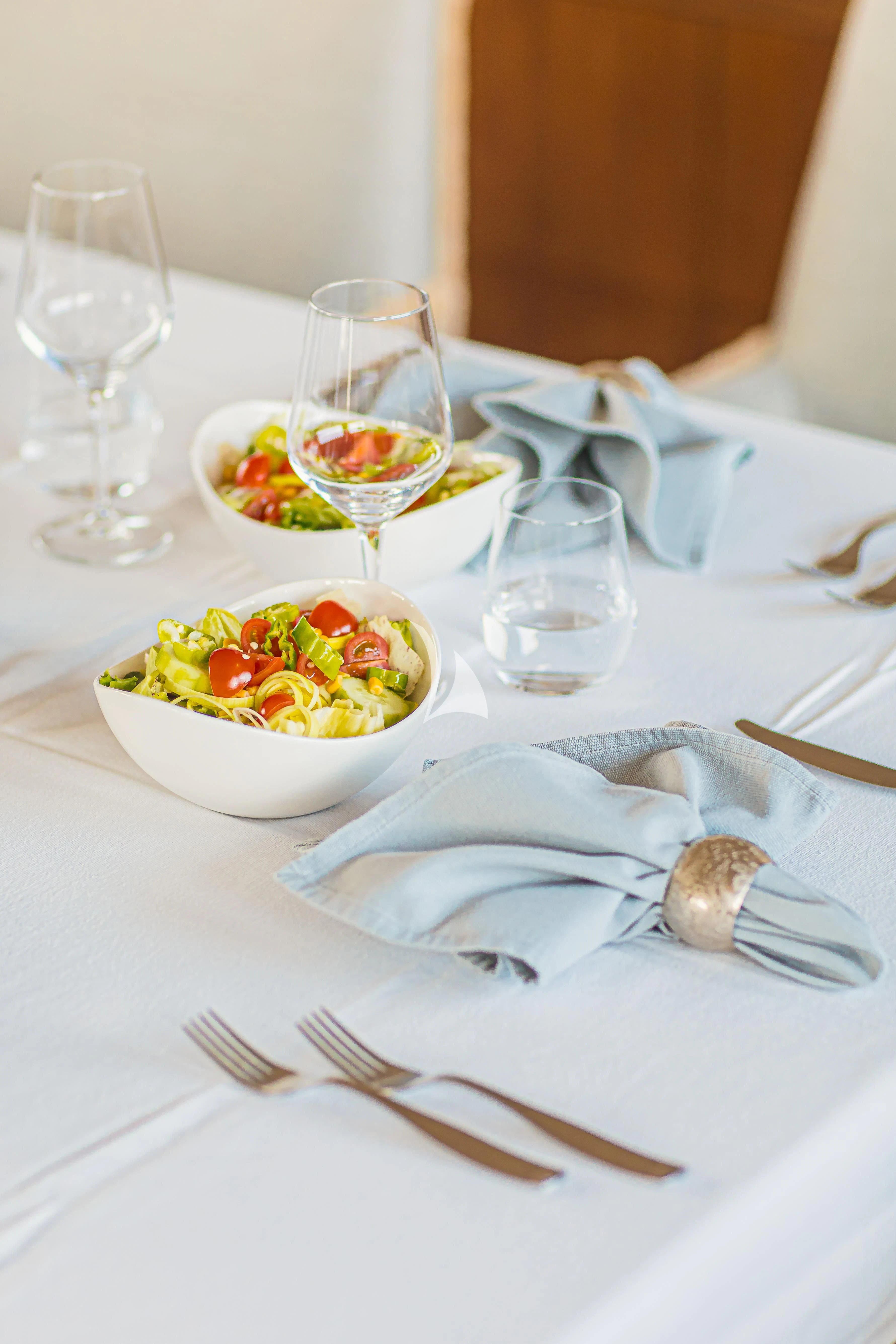 a plate of food and glasses aboard XO OF THE SEAS Yacht for Sale