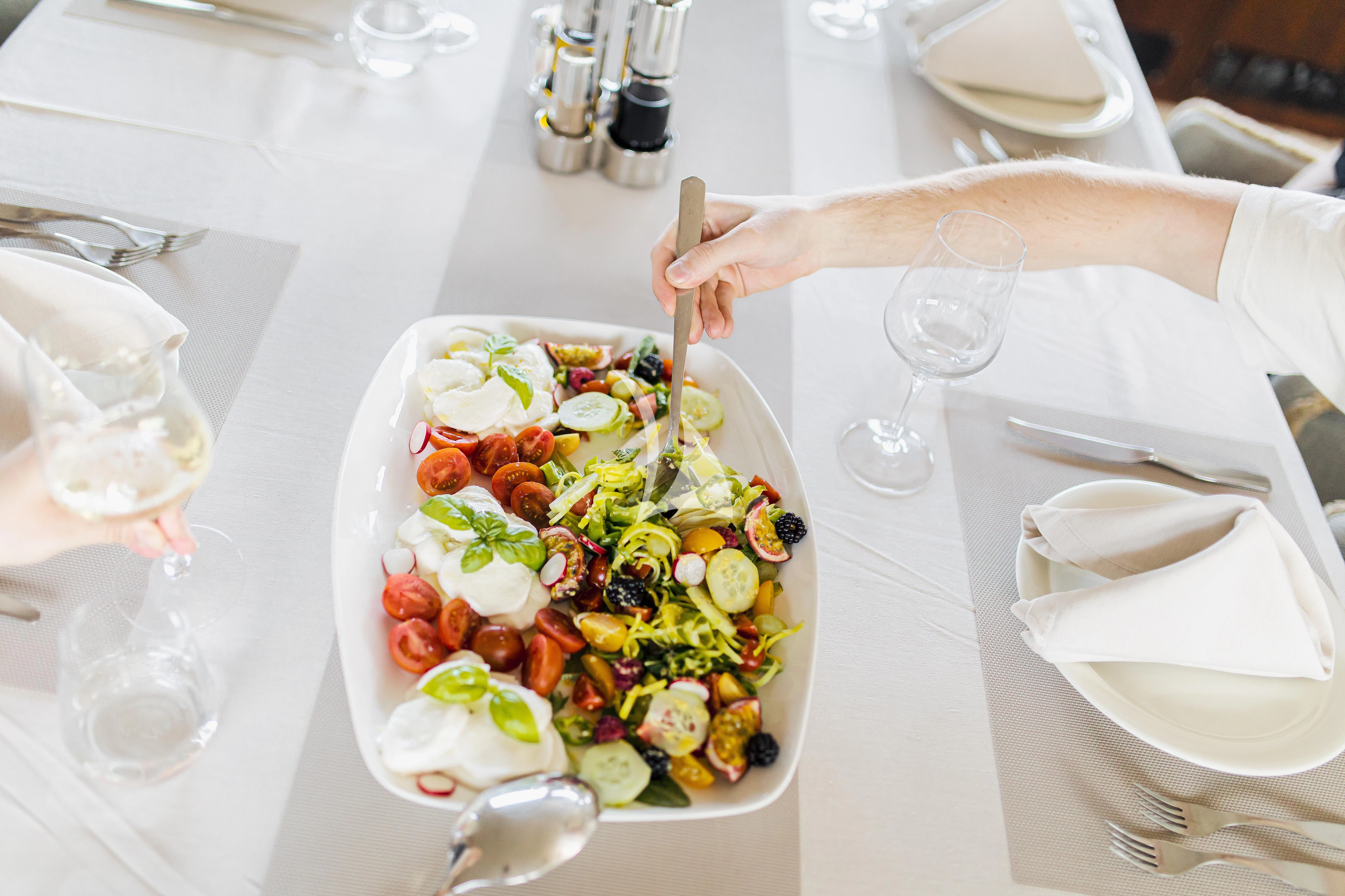 a person holding a fork and knife aboard XO OF THE SEAS Yacht for Sale
