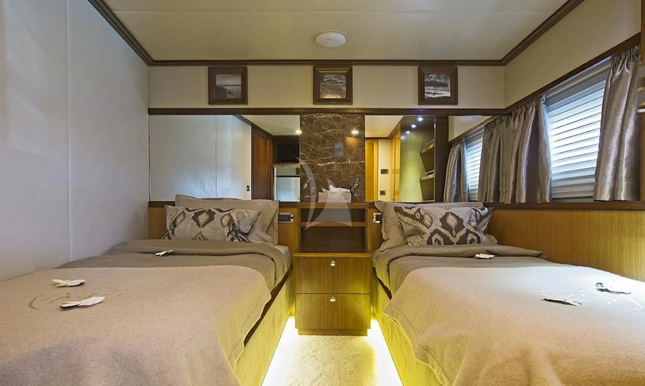 a room with beds and a tv aboard XO OF THE SEAS Yacht for Sale