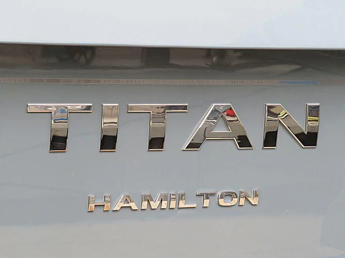 a grey and black logo aboard TITAN Yacht for Sale
