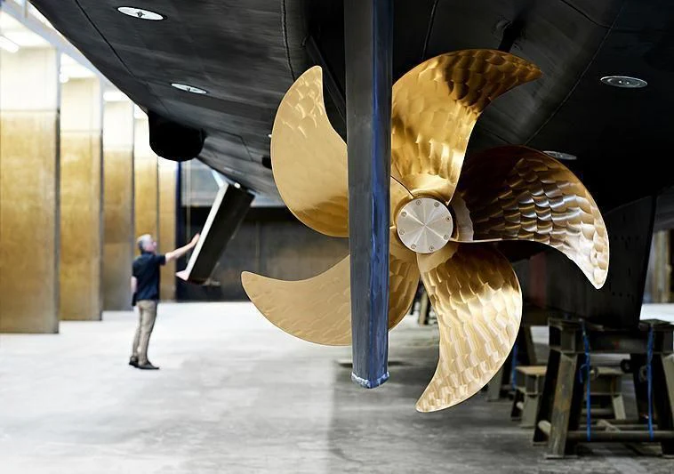 a person standing next to a large dinosaur aboard TOUTE SWEET Yacht for Sale