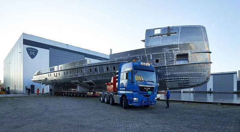 a truck parked next to a large boat aboard TOUTE SWEET Yacht for Sale
