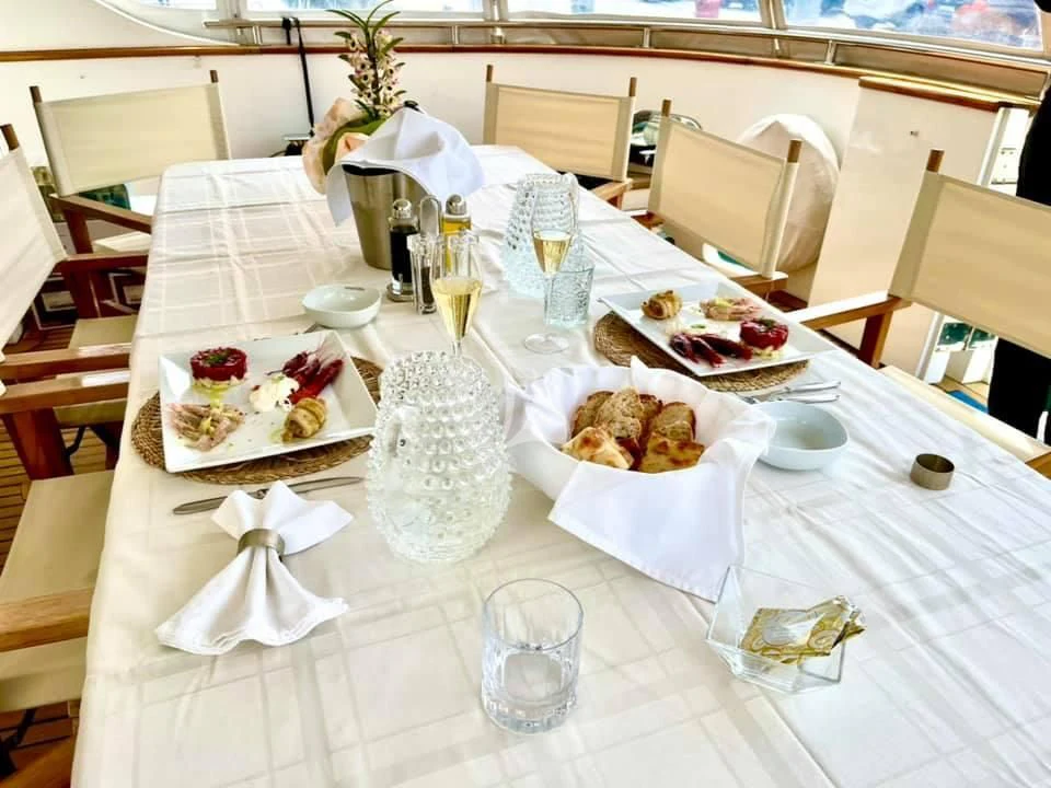 a table with plates and glasses aboard SHANGRA Yacht for Sale