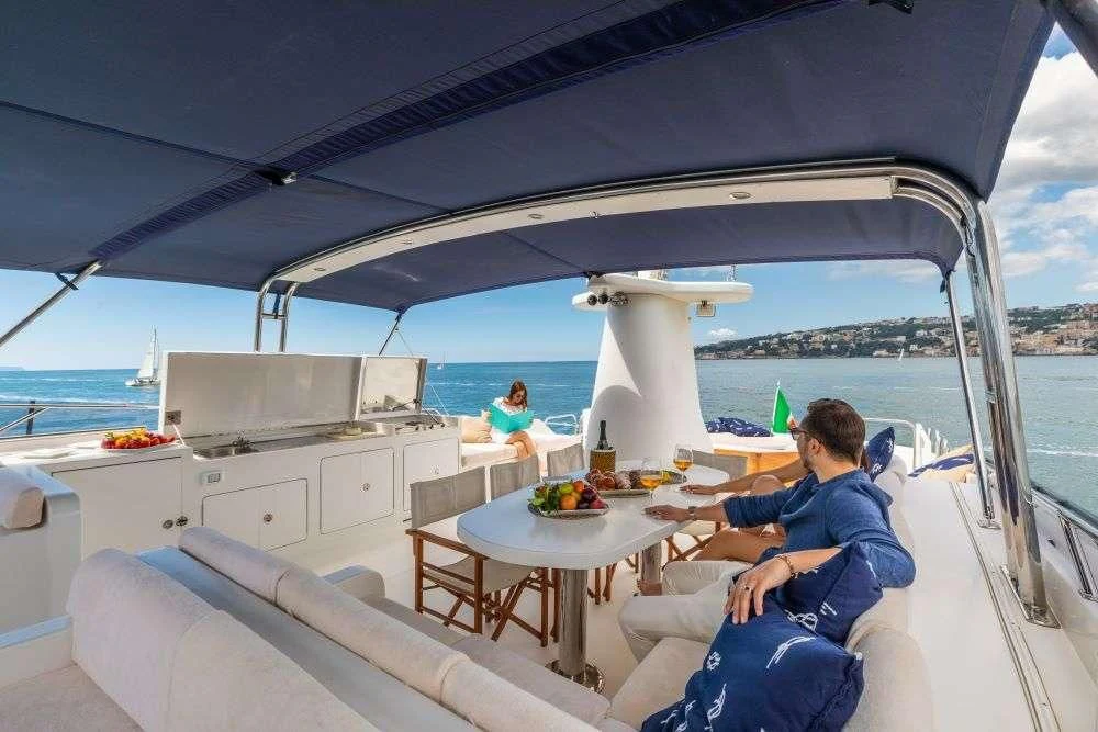 a person sitting at a table on a boat aboard SHANGRA Yacht for Sale