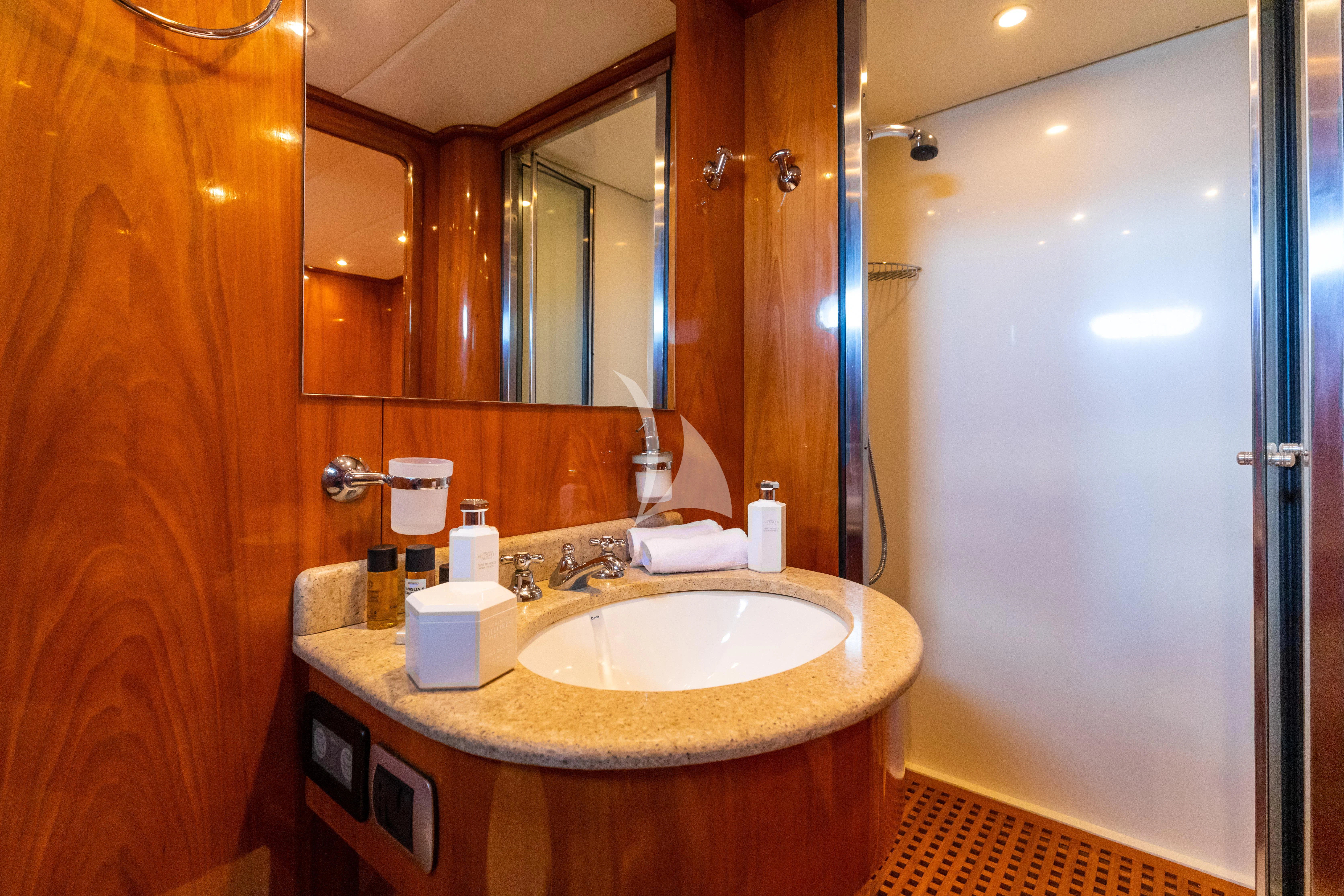 a bathroom with a sink and a mirror aboard SHANGRA Yacht for Sale