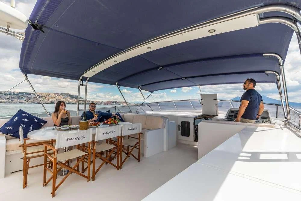 people sitting at a table under a tent aboard SHANGRA Yacht for Sale