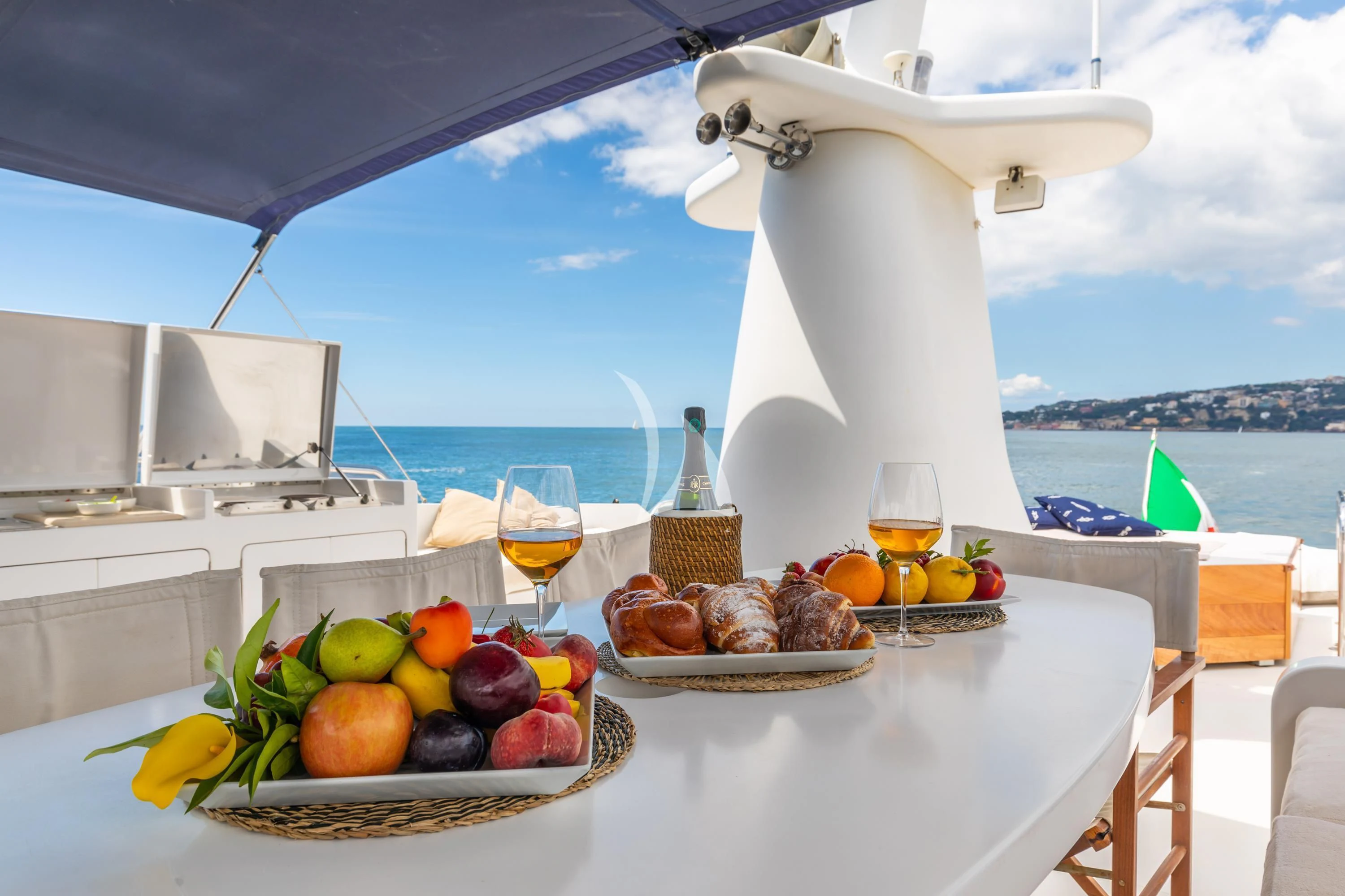 a table with food and drinks on it aboard SHANGRA Yacht for Sale