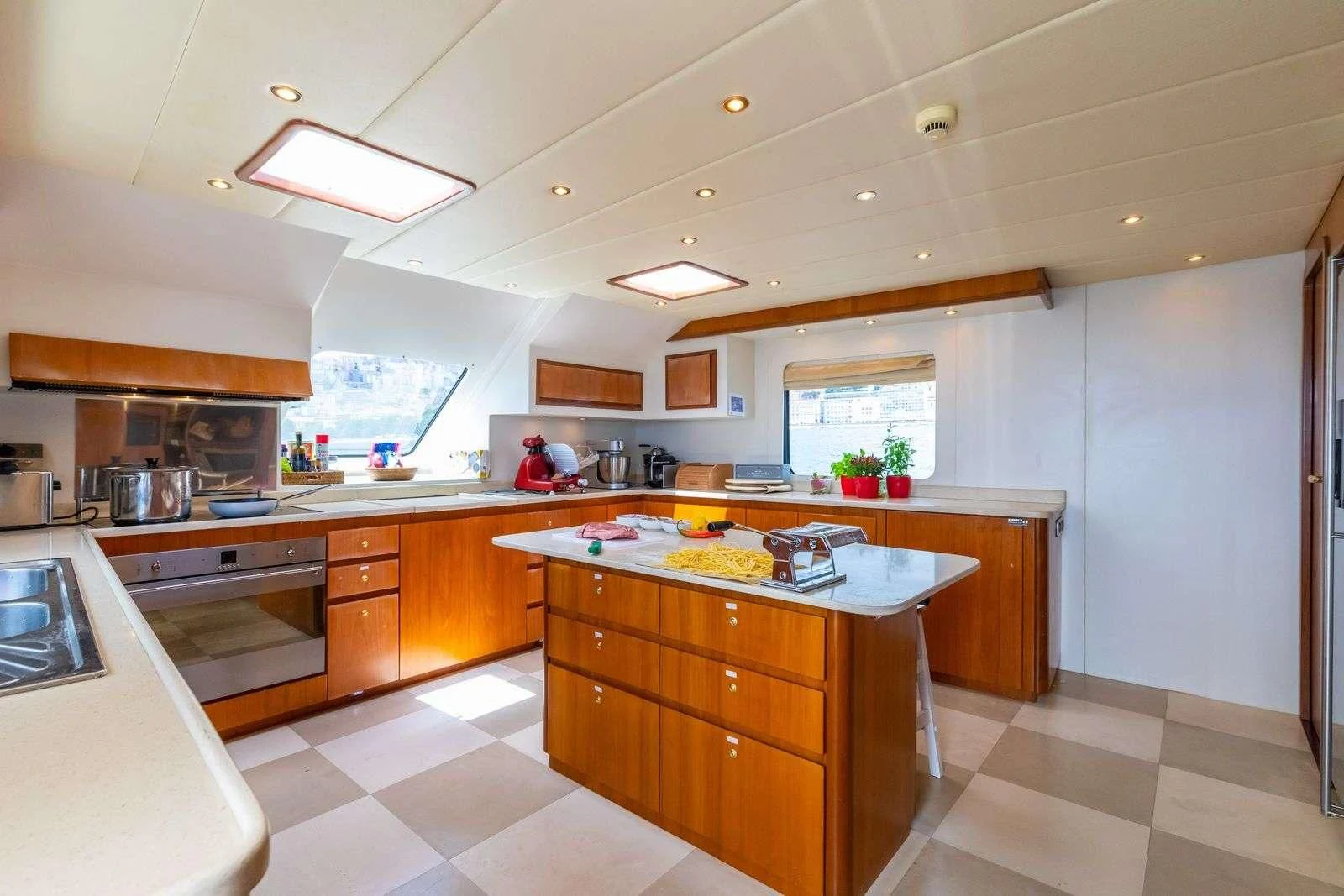 a kitchen with wooden cabinets aboard SHANGRA Yacht for Sale