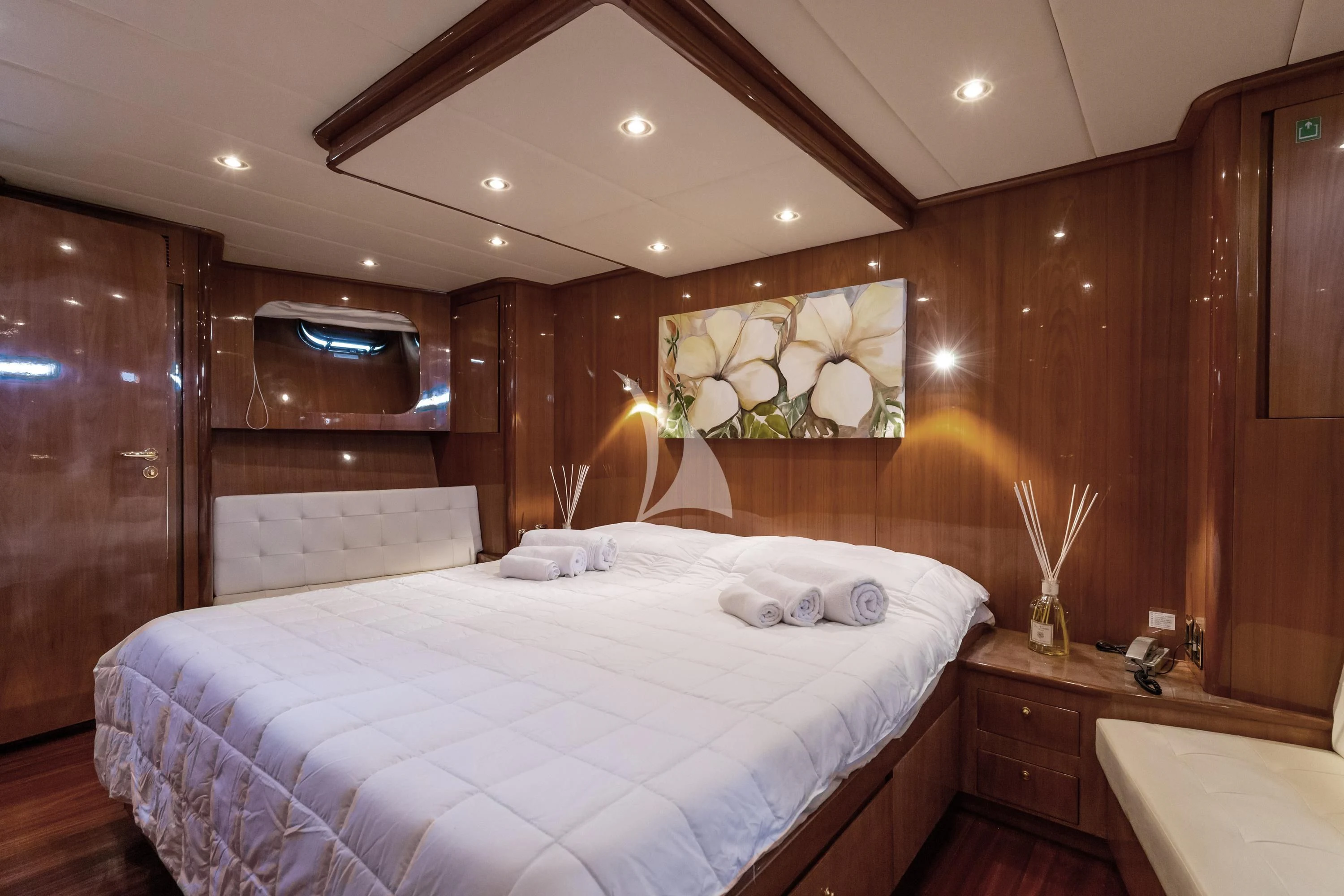 a bedroom with a bed and a wood wall aboard SHANGRA Yacht for Sale