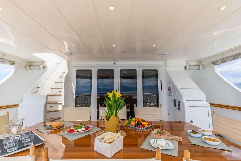 a kitchen with a table and chairs aboard SHANGRA Yacht for Sale