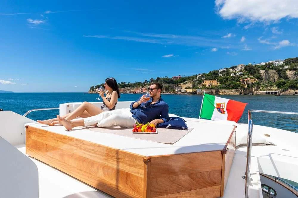 a man and woman sitting on a boat with a woman on the side aboard SHANGRA Yacht for Sale