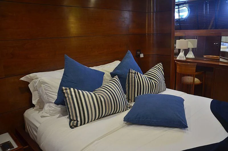 a bed with blue pillows aboard FIORENTE Yacht for Sale