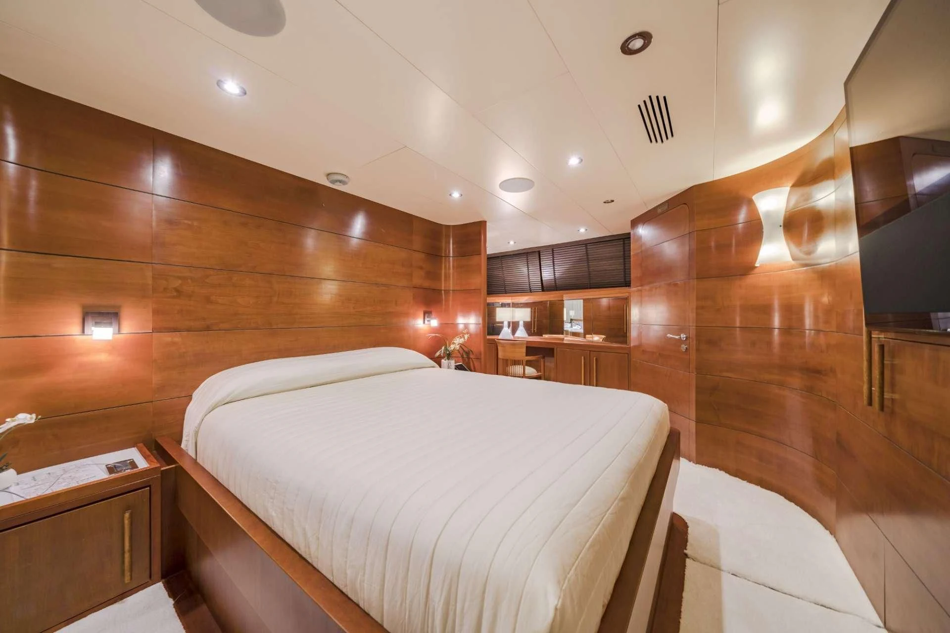 a room with a bed and a mirror aboard FIORENTE Yacht for Sale