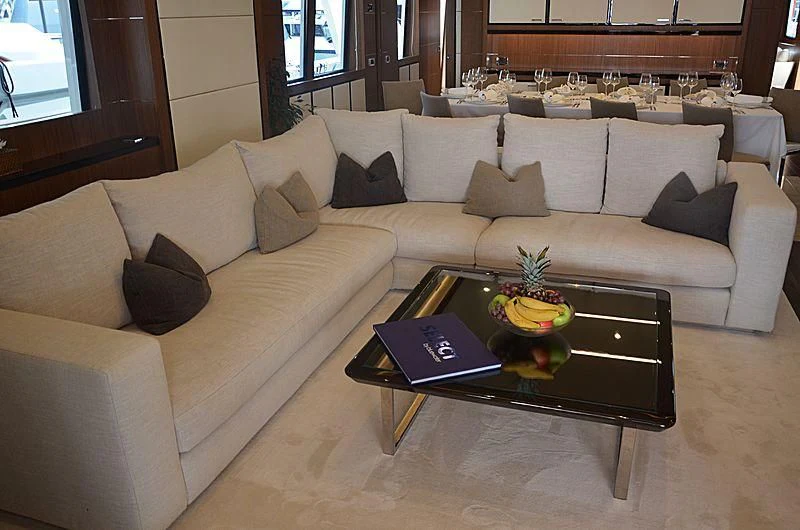 a living room with a couch and a coffee table aboard FIORENTE Yacht for Sale