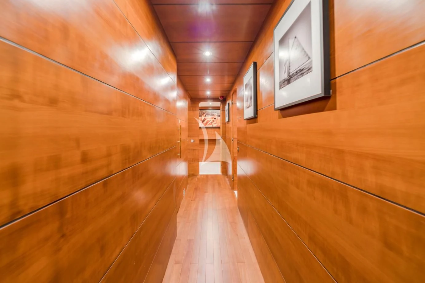 a wood hallway with framed pictures aboard FIORENTE Yacht for Sale