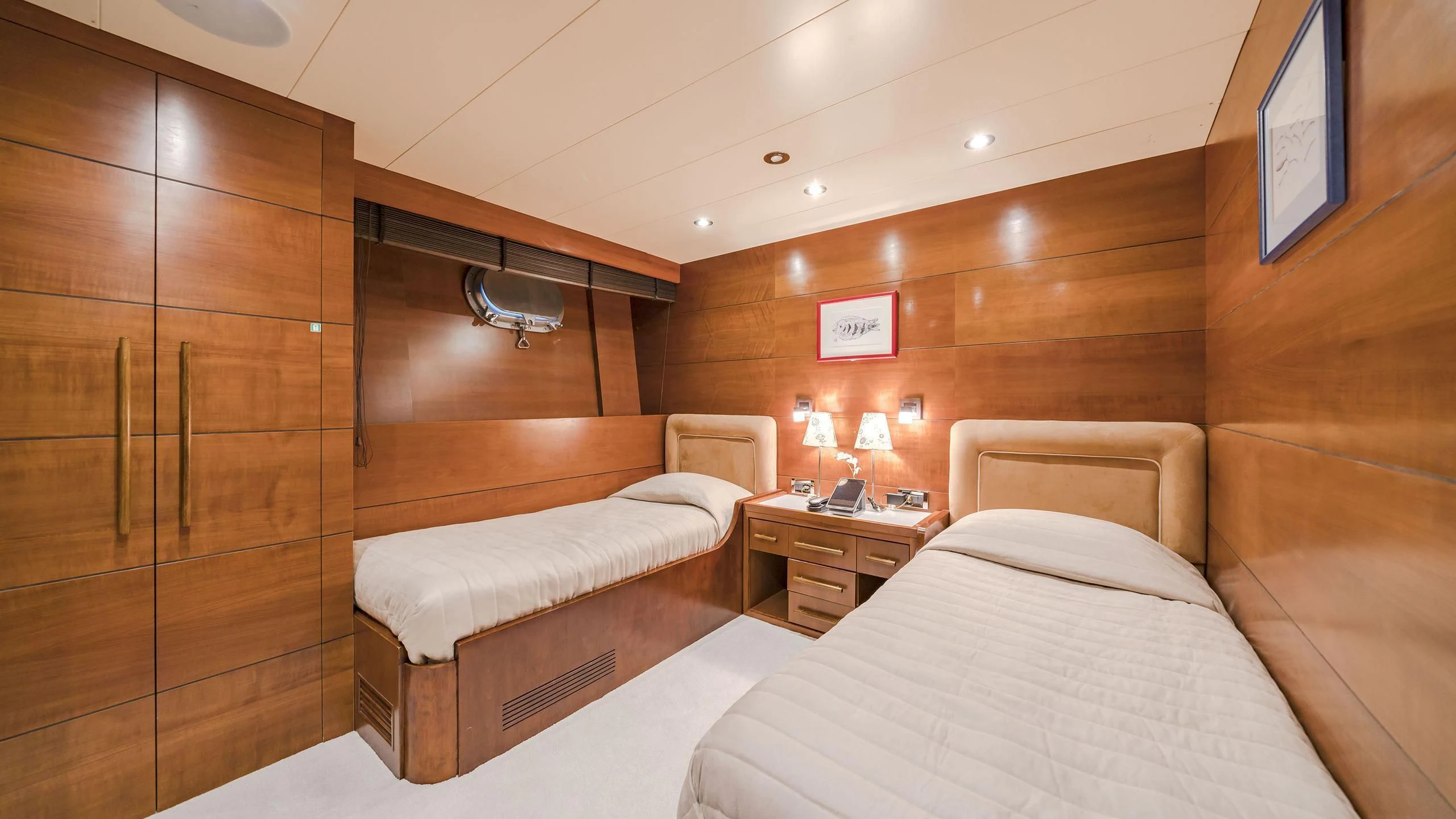 a room with a bed and a wood cabinet aboard FIORENTE Yacht for Sale