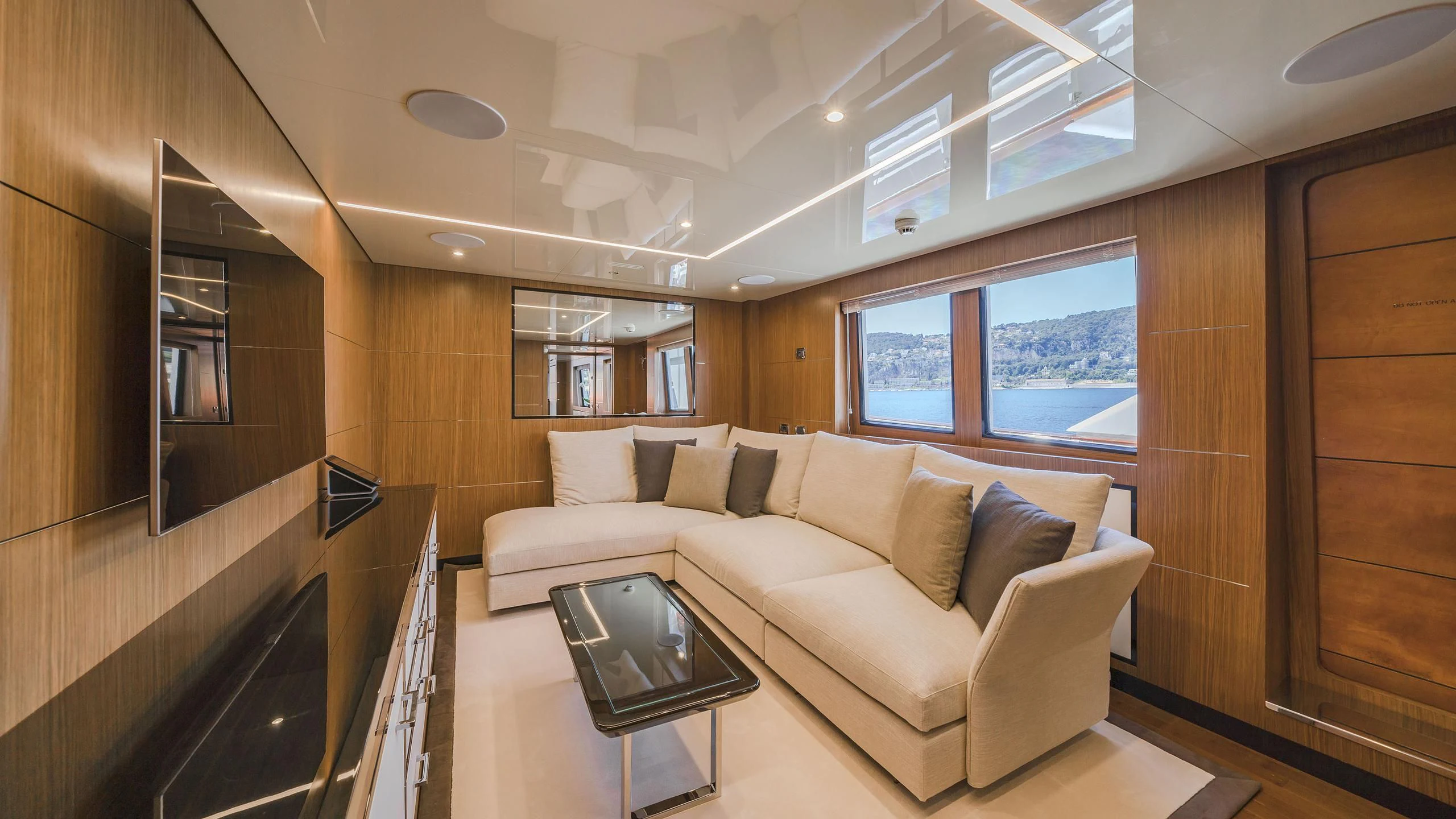 a living room with a couch and a coffee table aboard FIORENTE Yacht for Sale