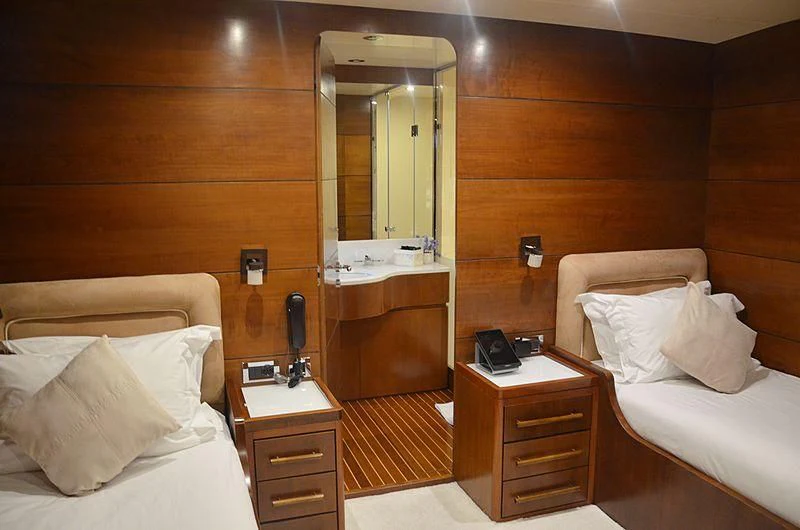 a room with a bed and a mirror aboard FIORENTE Yacht for Sale