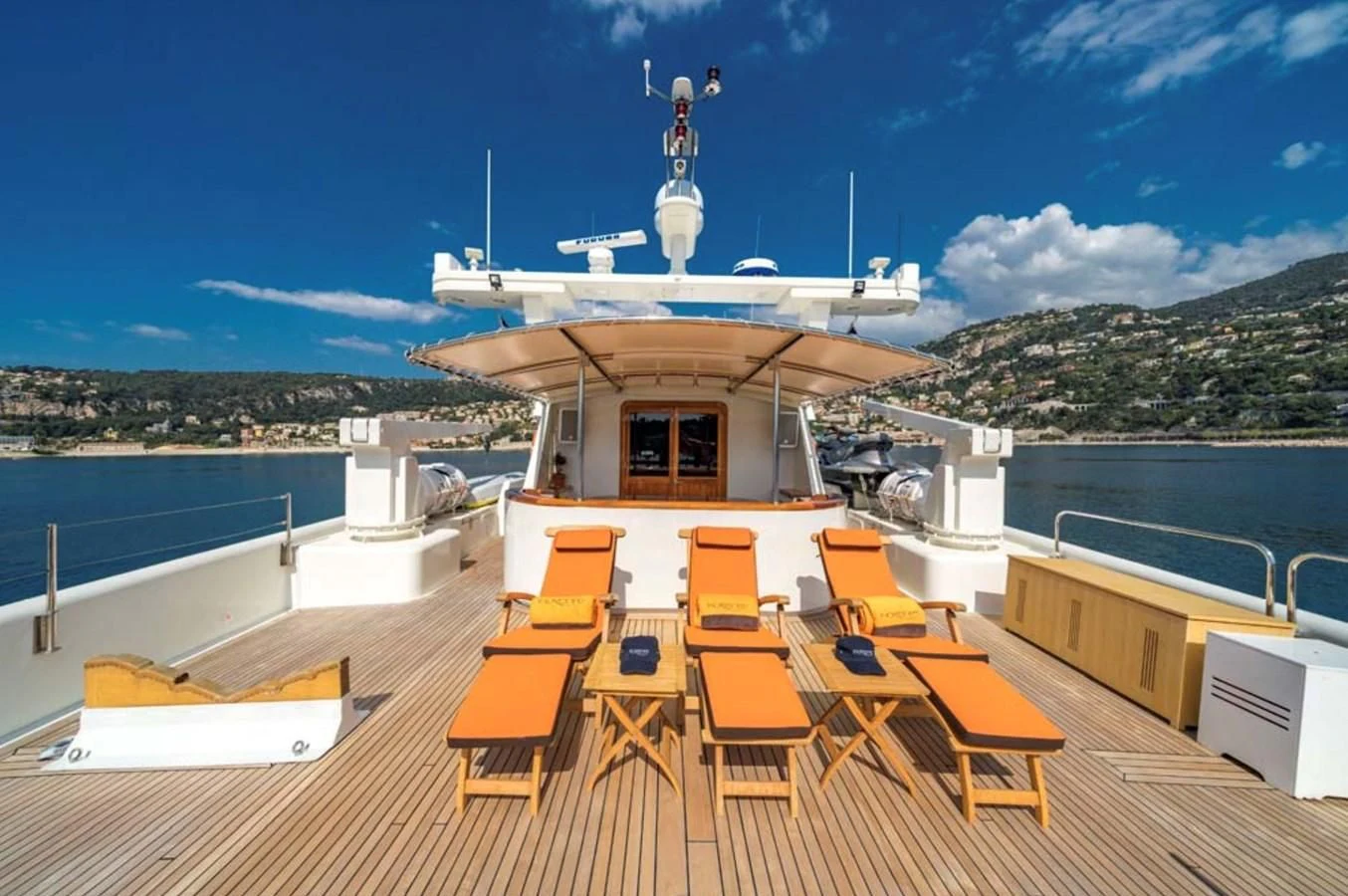 a deck with chairs and a boat on it aboard FIORENTE Yacht for Sale