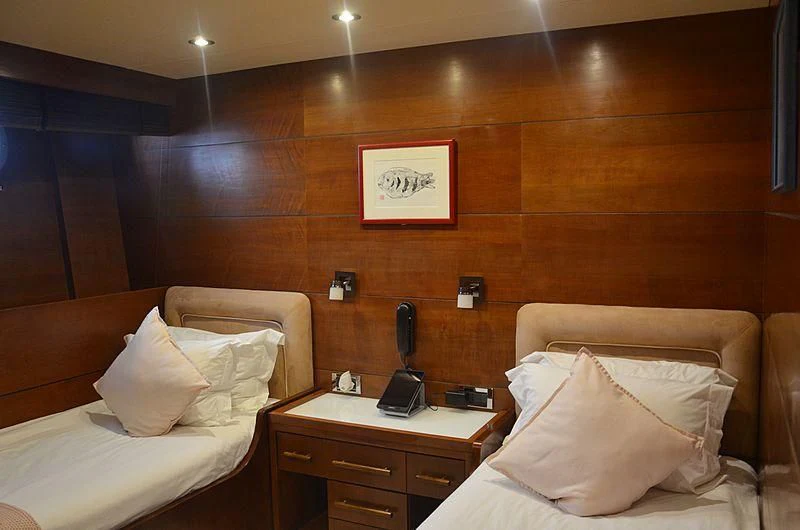 a hotel room with a bed and a phone aboard FIORENTE Yacht for Sale