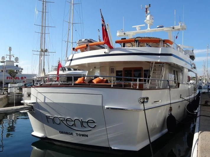 a large white boat in a harbor aboard FIORENTE Yacht for Sale