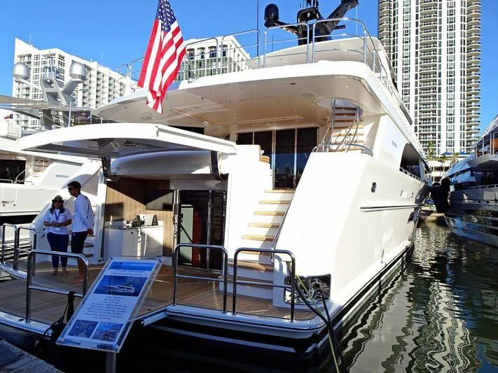 a large white boat with a flag on the front aboard FREEDOM Yacht for Sale