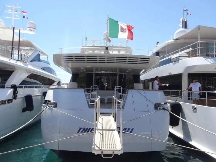 a boat with flags on it aboard THUNDERBALL I Yacht for Sale