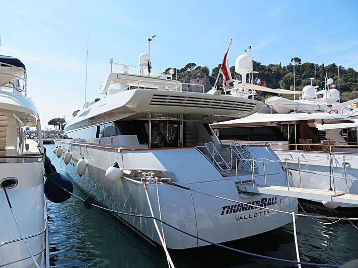 a couple of boats are parked in a harbor aboard THUNDERBALL I Yacht for Sale
