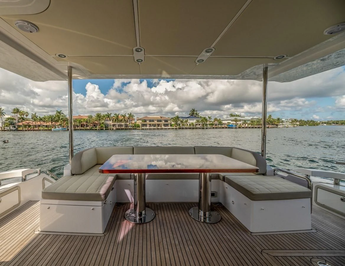 a table and a couch on a boat in the water aboard BAR BAT VIA Yacht for Sale