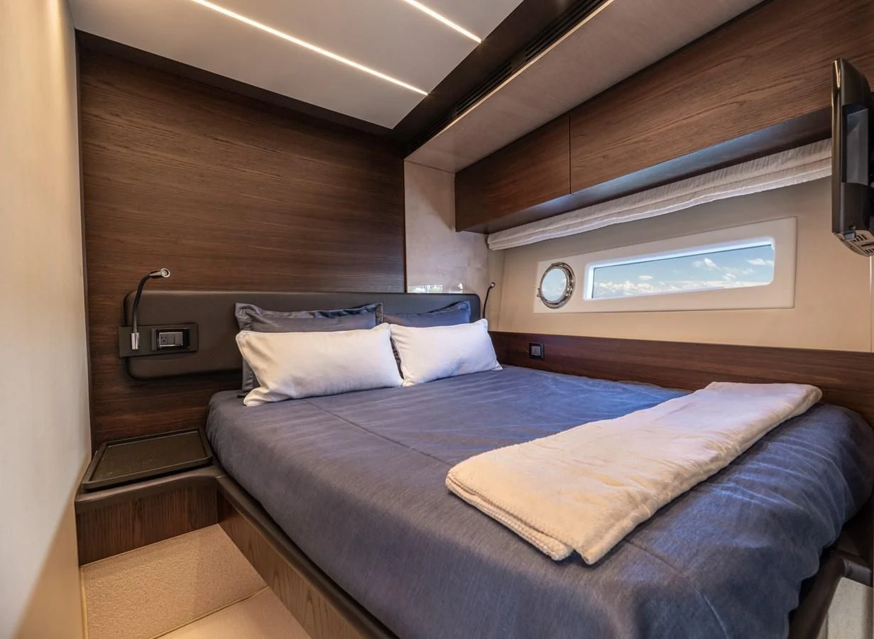 a bed with a blue sheet aboard BAR BAT VIA Yacht for Sale