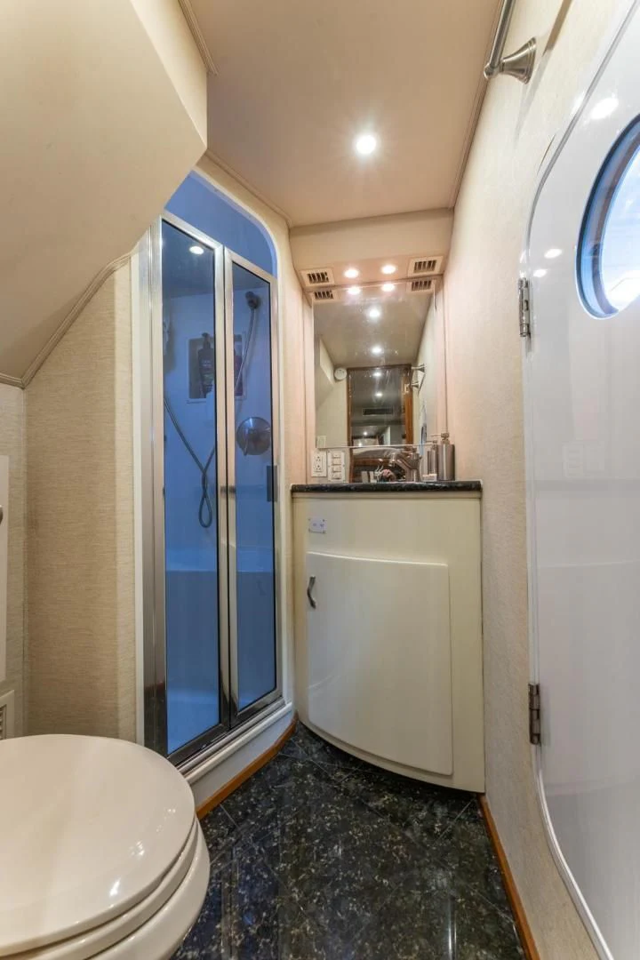 a bathroom with a blue shower door aboard SALT STRUK Yacht for Sale