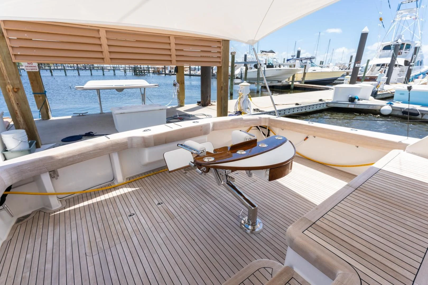 a deck with a boat and a table on it aboard SALT STRUK Yacht for Sale