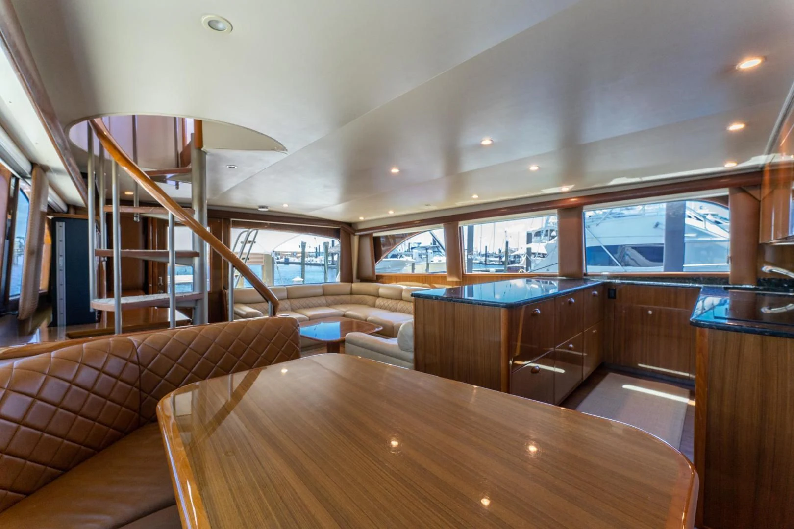 a room with a wood table and couches aboard SALT STRUK Yacht for Sale