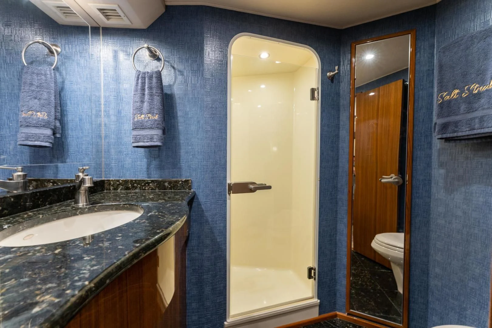 a bathroom with a sink and a mirror aboard SALT STRUK Yacht for Sale