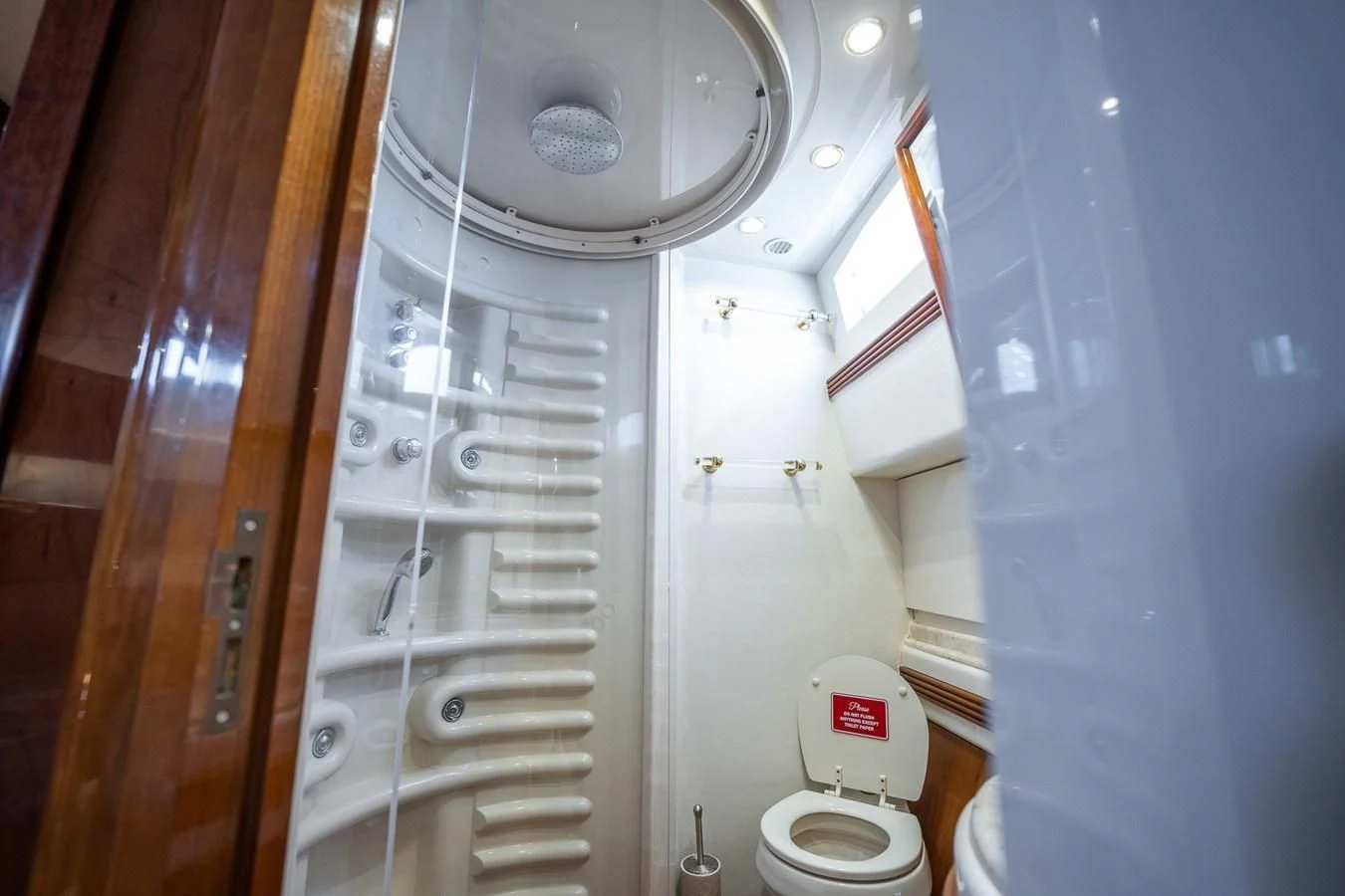 a bathroom with a toilet and shower aboard 80 CARAT Yacht for Sale