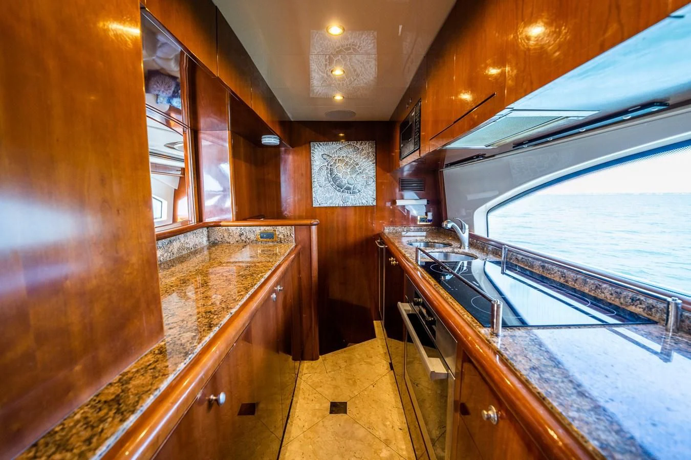 a kitchen with wooden cabinets aboard 80 CARAT Yacht for Sale