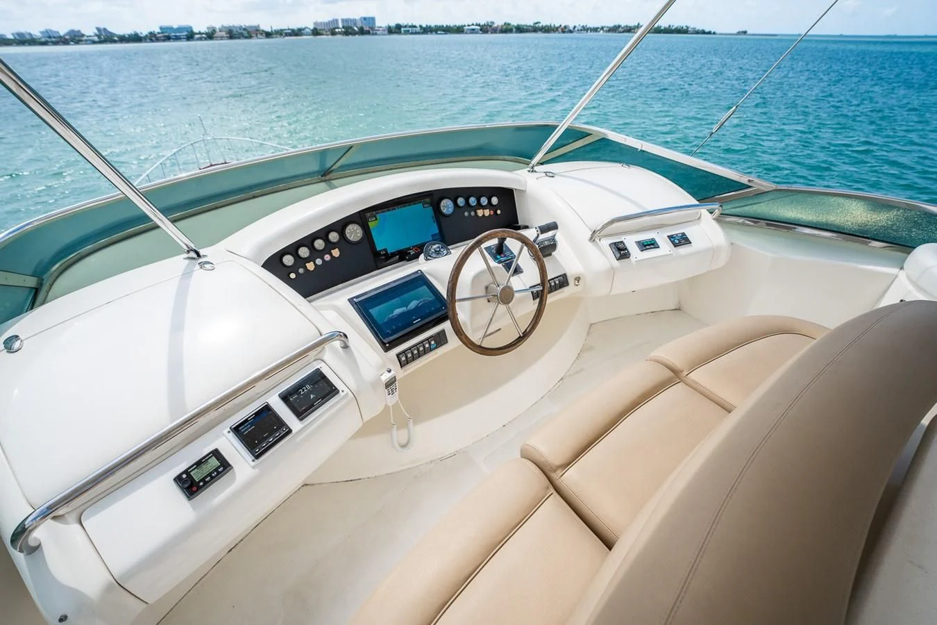 a boat with a steering wheel and dashboard on the water aboard 80 CARAT Yacht for Sale
