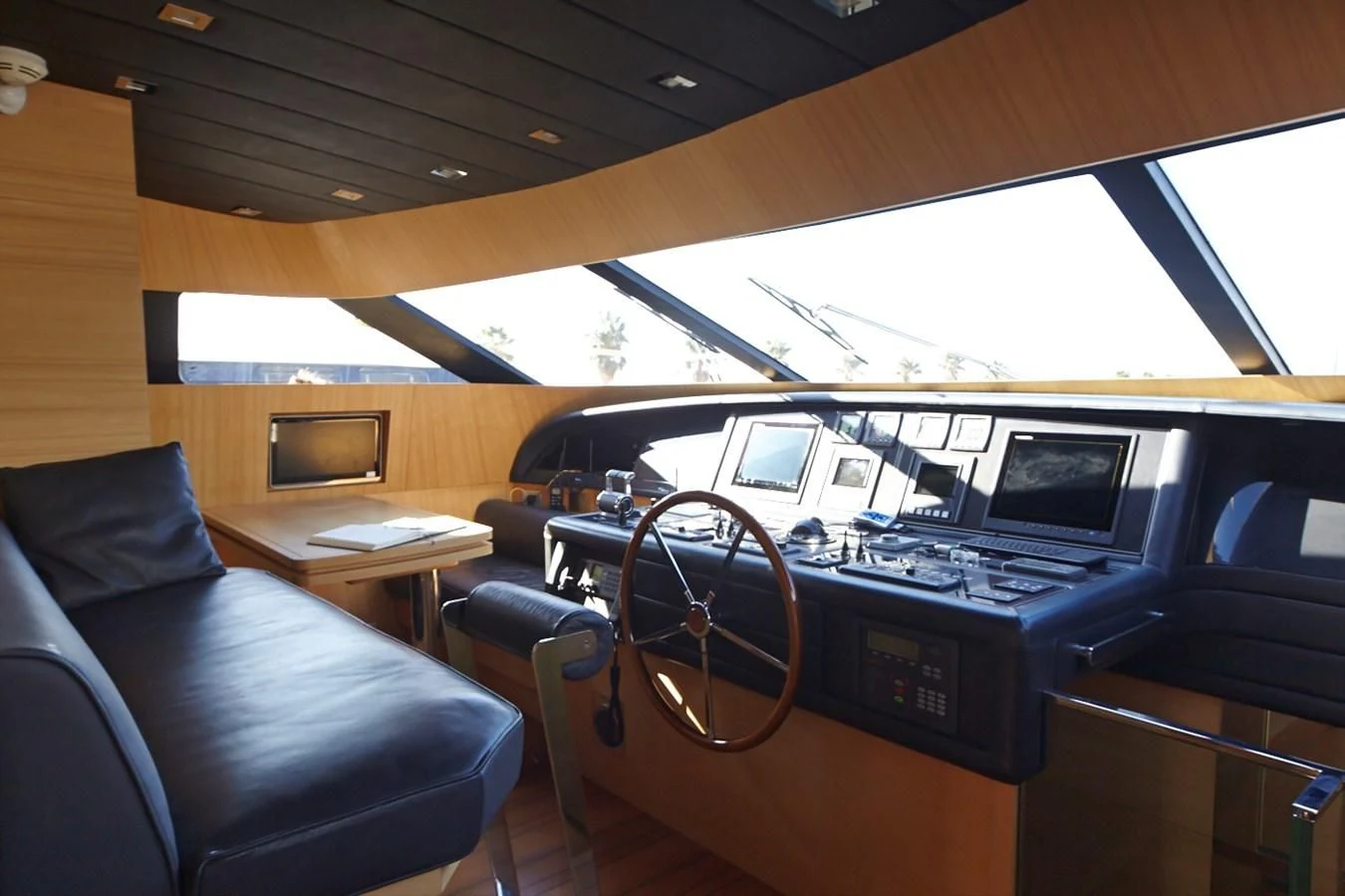 inside of a vehicle with a desk and a couch and a computer aboard GULU Yacht for Sale