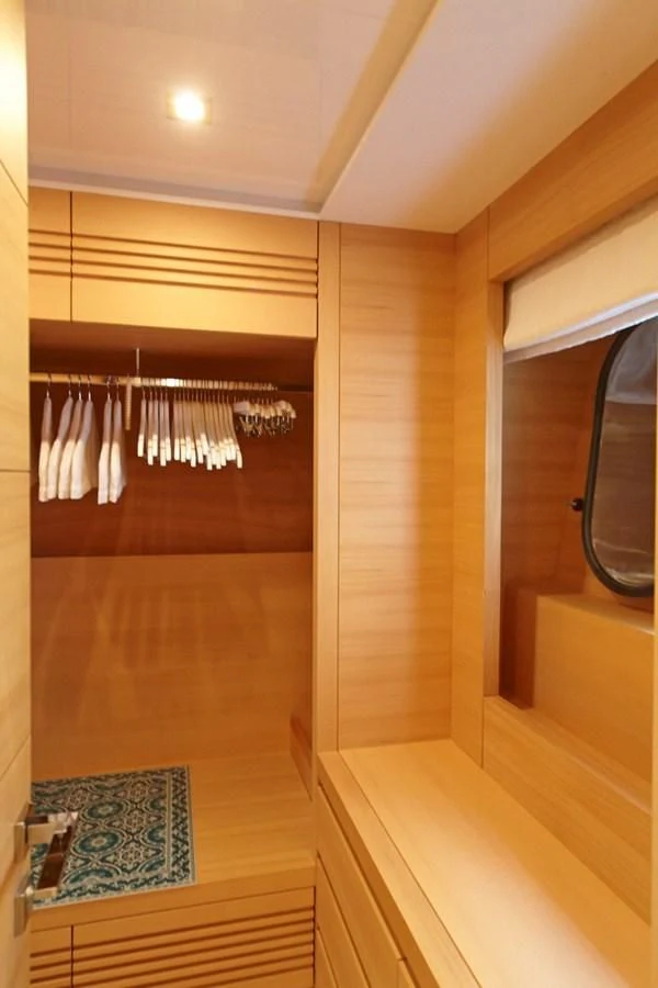 a room with a wood floor and a window with curtains aboard GULU Yacht for Sale
