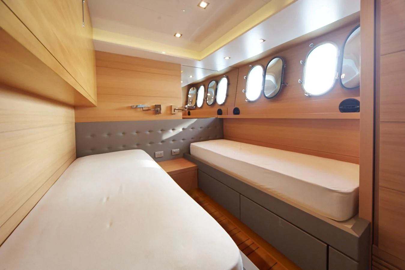 a room with a bed and a mirror aboard GULU Yacht for Sale