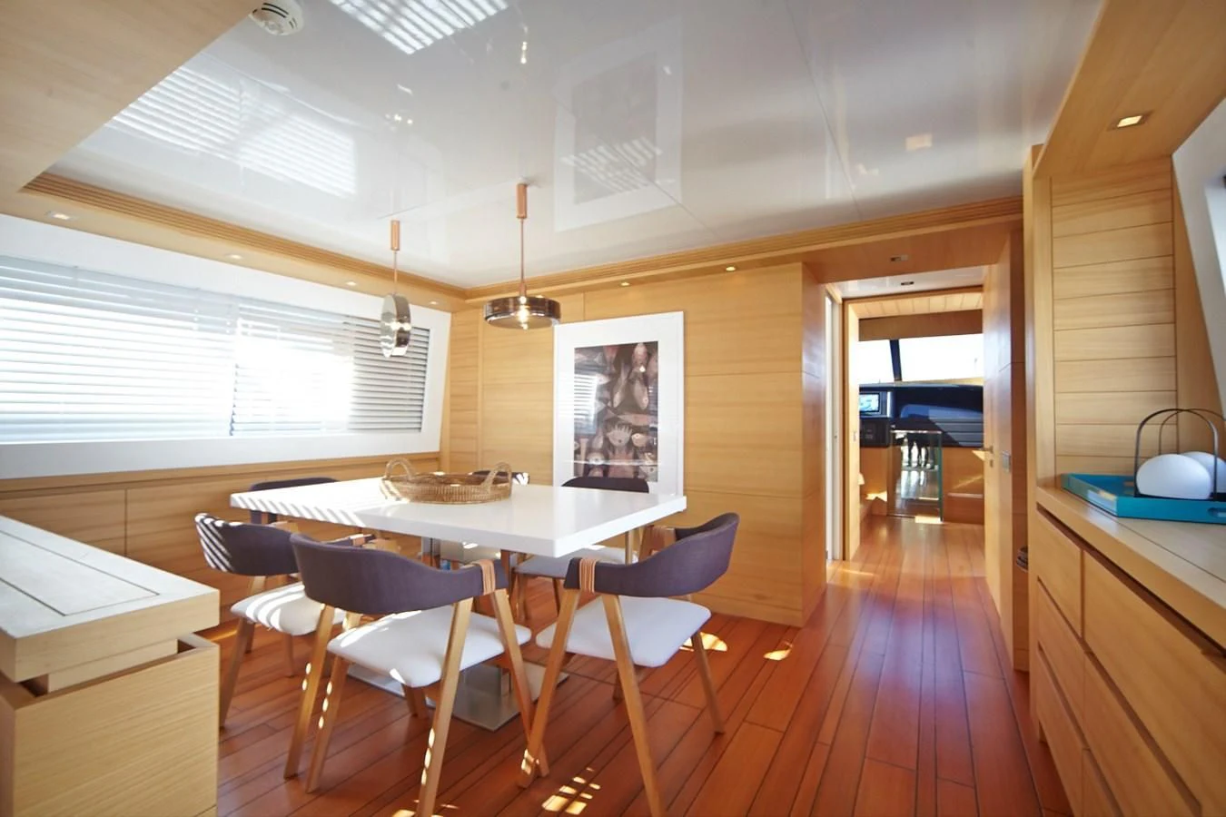 a kitchen with a table and chairs aboard GULU Yacht for Sale